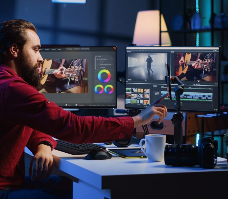 Video editor content creator pressing record button on phone, filming tutorial about professionally trimming footage segments. Videographer teaching online audiences to splice clips