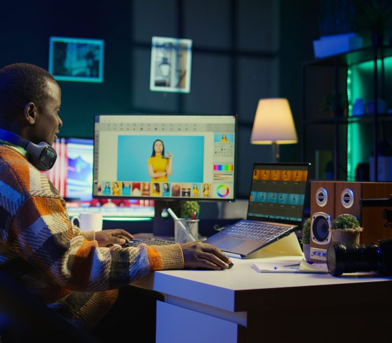 Videography specialist editing new movie clip for video montage, working on freelance contract for post production agency. Creative designer adjusting contrast using toolbar panels. Camera B.